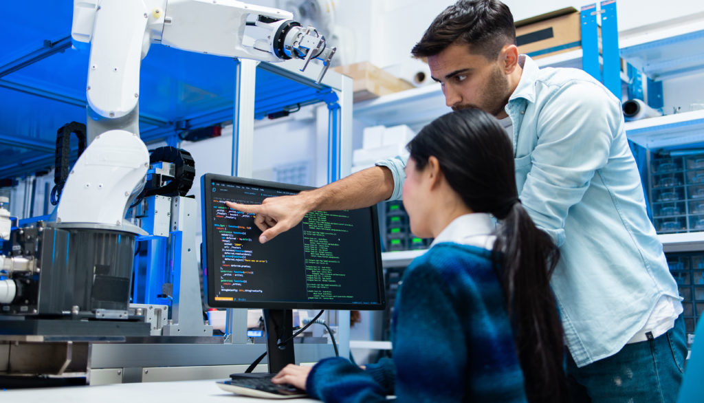 Man pointing to code on a monitor