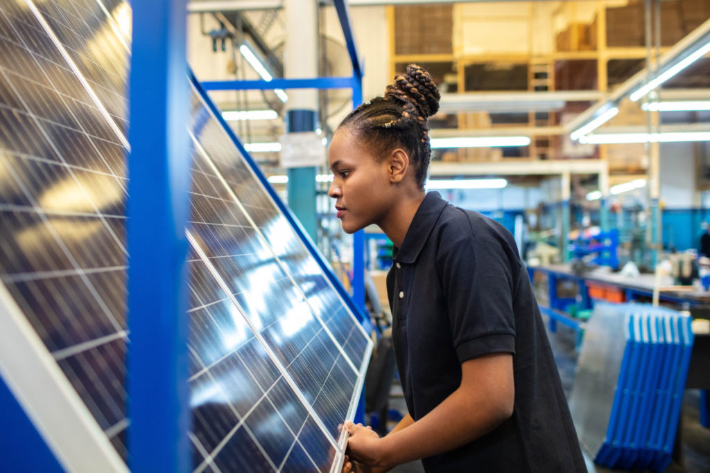 Woman in front of solar panel