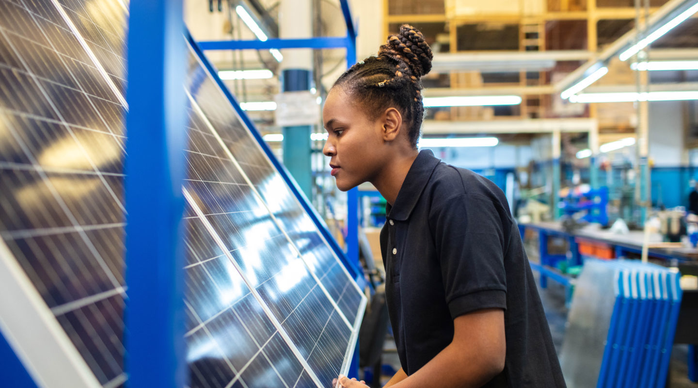 Woman in front of solar panel