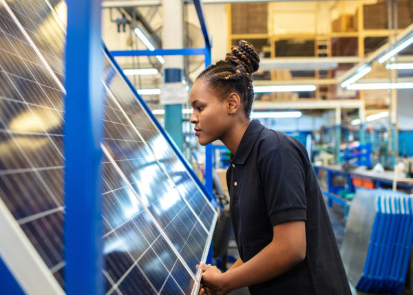 Woman in front of solar panel