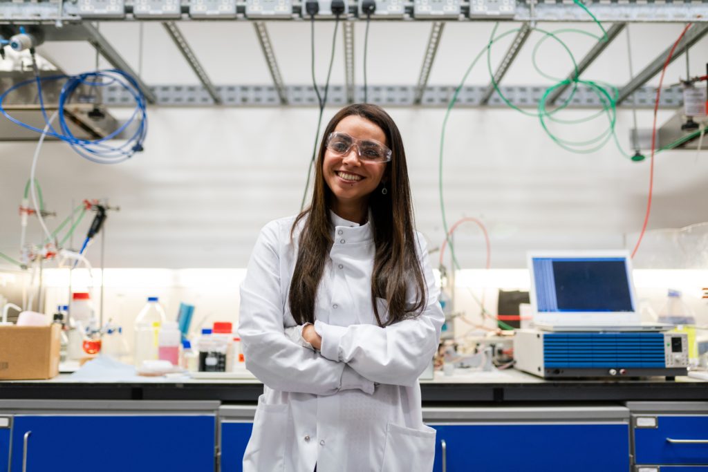 Woman smiling in a lab coat