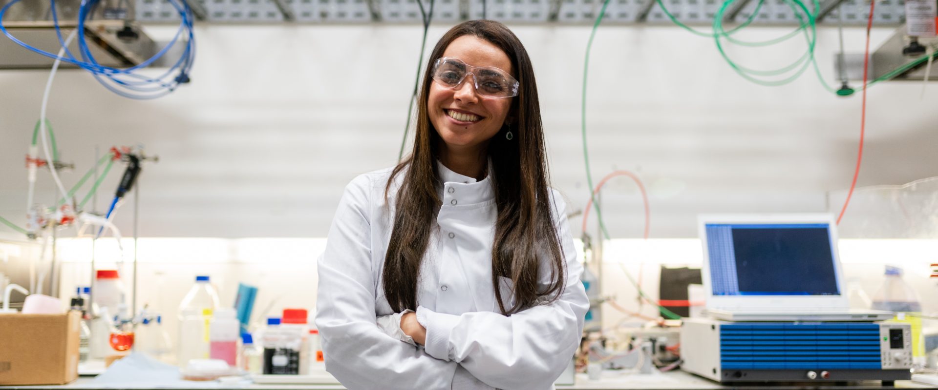 Woman smiling in a lab coat